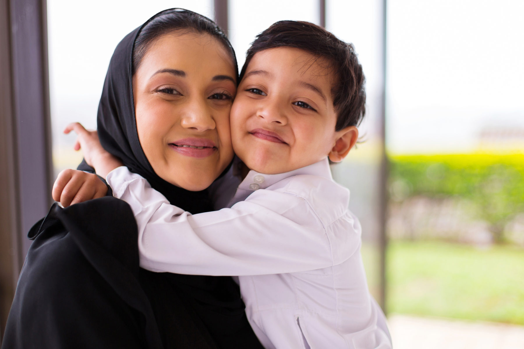 Muslim boy hugging his mother